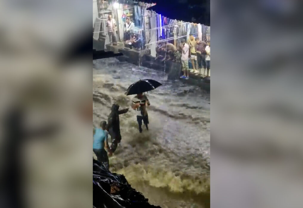 Dramatic! Man struggles to navigate flooded street in western India