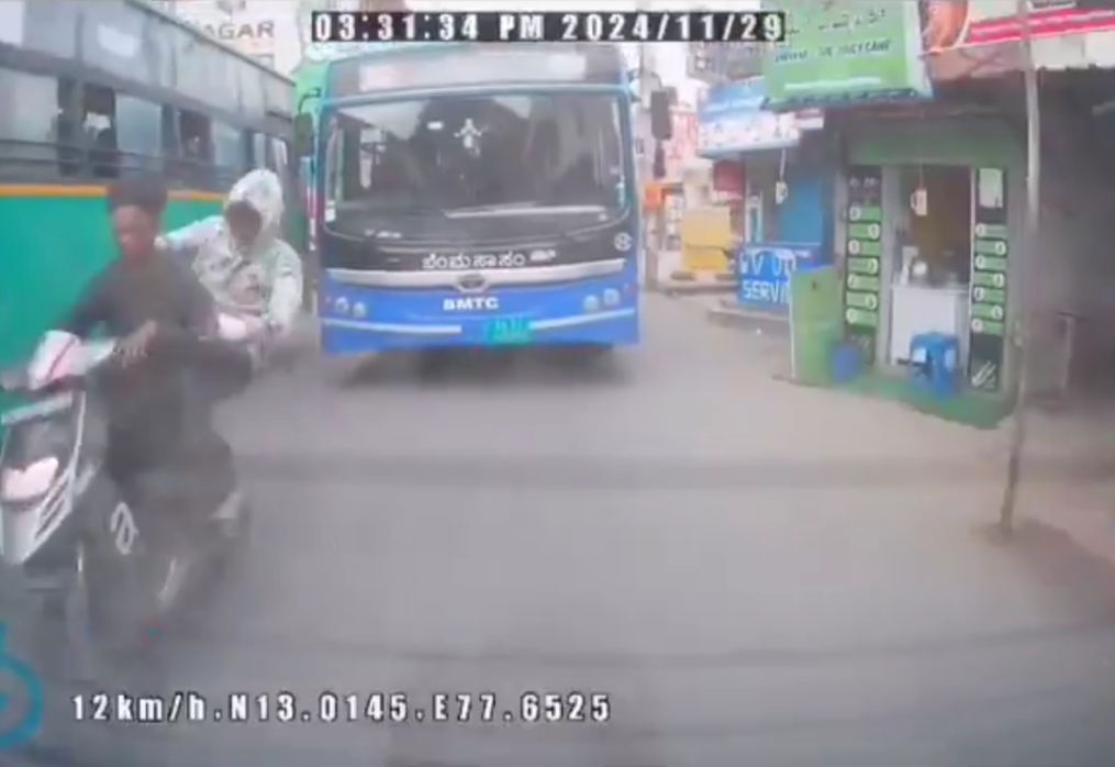 Biker cheats death after being sandwiched between two buses